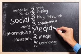 man writing social media terms on blackboard